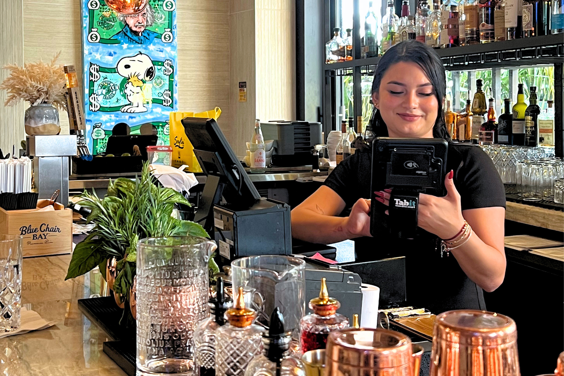 Tabit handheld POS used by restaurant staff at the bar